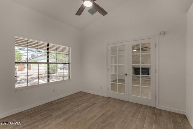 723 E Piute Ave, Phoenix, AZ 85024 - spare room featuring ceiling fan, vaulted ceiling, wood finished floors, and french doors