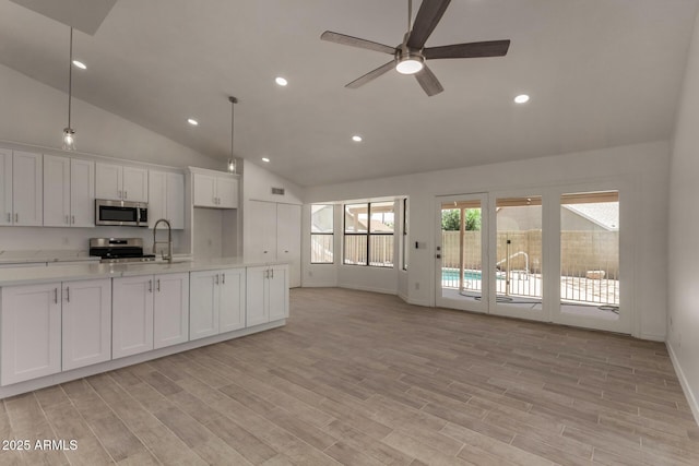 723 E Piute Ave, Phoenix, AZ 85024 - kitchen with stainless steel appliances, light countertops, ceiling fan, white cabinetry, and open floor plan