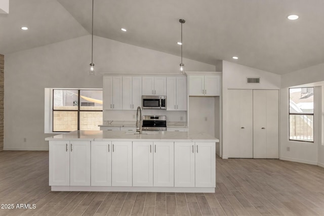 723 E Piute Ave, Phoenix, AZ 85024 - kitchen featuring stainless steel microwave, white cabinets, range, high vaulted ceiling, and light wood-style flooring