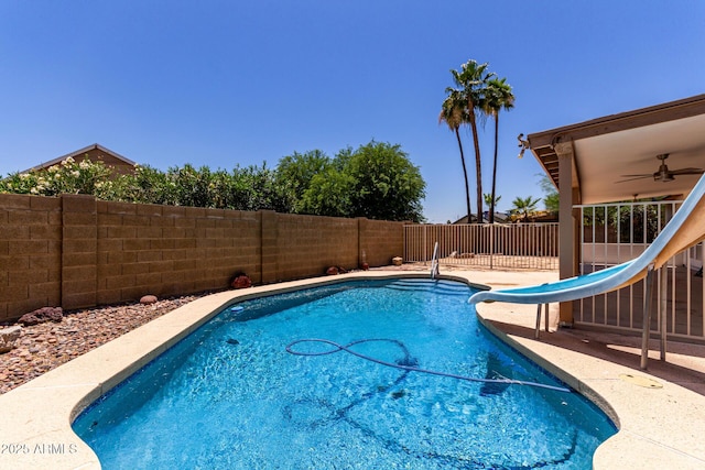 723 E Piute Ave, Phoenix, AZ 85024 - view of pool with a water slide, a fenced backyard, and a ceiling fan