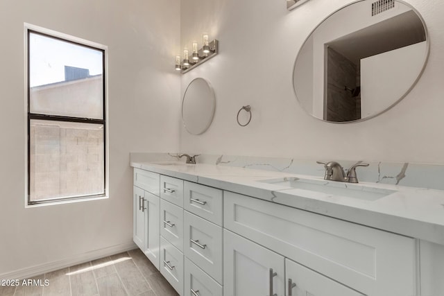 723 E Piute Ave, Phoenix, AZ 85024 - bathroom featuring double vanity and baseboards
