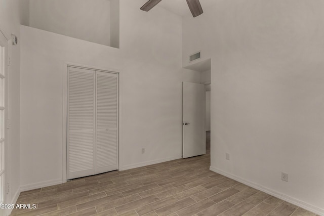 723 E Piute Ave, Phoenix, AZ 85024 - unfurnished bedroom with light wood-style flooring, a high ceiling, a closet, and a ceiling fan