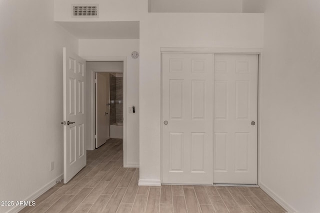 723 E Piute Ave, Phoenix, AZ 85024 - unfurnished bedroom with light wood finished floors and a closet