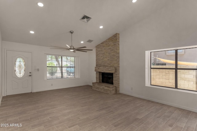 723 E Piute Ave, Phoenix, AZ 85024 - unfurnished living room featuring a stone fireplace, a ceiling fan, light wood-type flooring, high vaulted ceiling, and recessed lighting