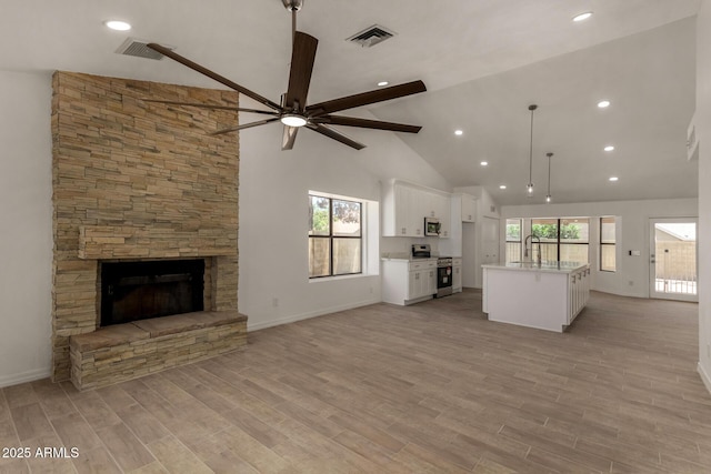 723 E Piute Ave, Phoenix, AZ 85024 - unfurnished living room featuring a ceiling fan, a fireplace, high vaulted ceiling, recessed lighting, and light wood finished floors