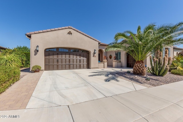 mediterranean / spanish home with a garage