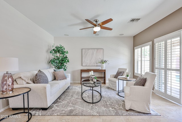 living area with visible vents and a ceiling fan