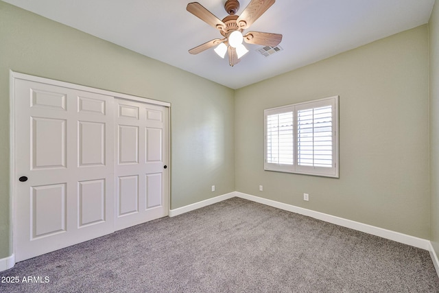 unfurnished bedroom with carpet floors, baseboards, a closet, and visible vents