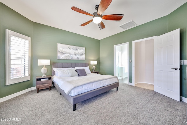 bedroom with visible vents, baseboards, ceiling fan, carpet, and ensuite bath