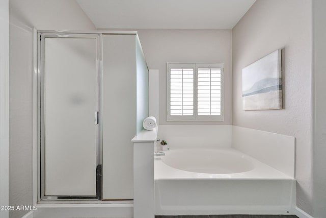 bathroom with a garden tub and a stall shower