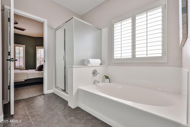 bathroom featuring connected bathroom, a bath, and a stall shower