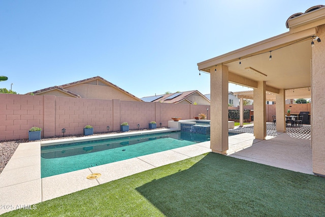 view of swimming pool with a lawn, a fenced backyard, a patio area, and a pool with connected hot tub