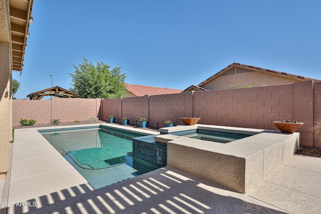 view of swimming pool with a fenced backyard, a fenced in pool, and an in ground hot tub