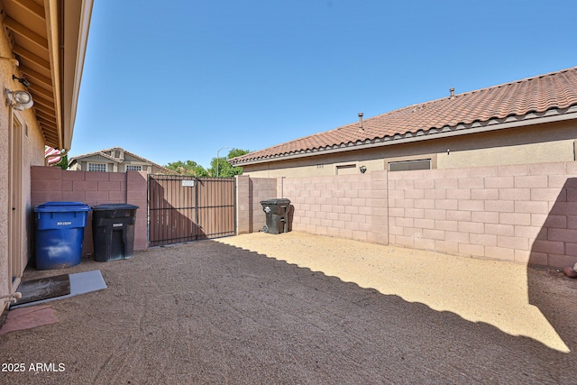 view of yard with fence and a gate