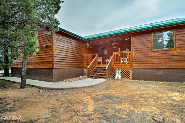 3047 Ponderosa Rd, Overgaard, AZ 85933 - view of front of house with metal roof, a wooden deck, and crawl space