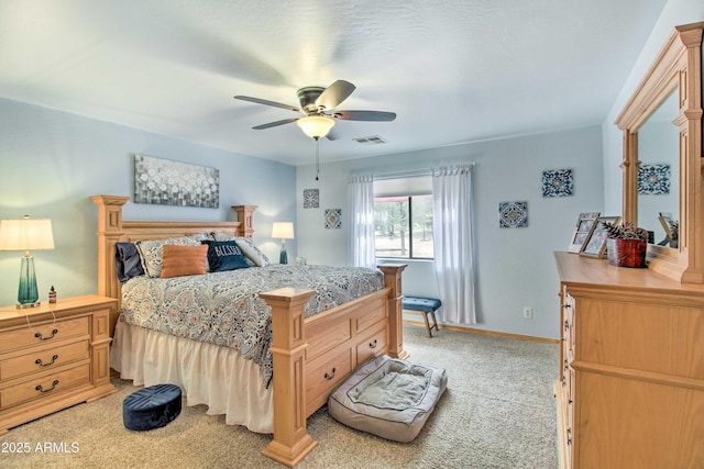 3047 Ponderosa Rd, Overgaard, AZ 85933 - bedroom with light colored carpet, visible vents, ceiling fan, and baseboards