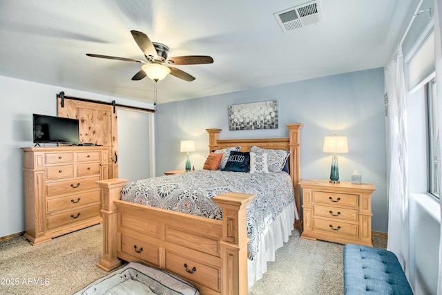 3047 Ponderosa Rd, Overgaard, AZ 85933 - bedroom featuring multiple windows, a barn door, light colored carpet, and visible vents