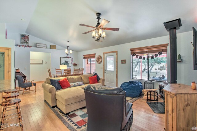 3047 Ponderosa Rd, Overgaard, AZ 85933 - living room with lofted ceiling, ceiling fan, a wood stove, and light wood-style floors