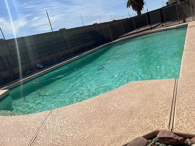 view of swimming pool with a fenced in pool and fence