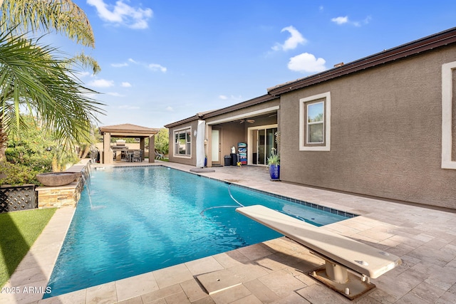 outdoor pool featuring a gazebo, a ceiling fan, and a patio