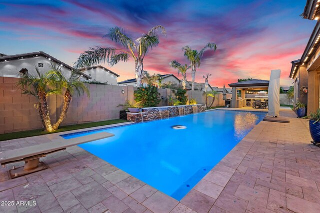 pool at dusk featuring a gazebo, a fenced in pool, a patio, and a fenced backyard