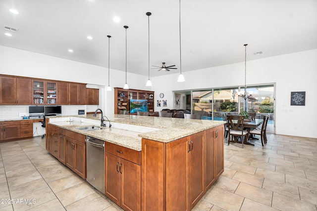 kitchen featuring visible vents, ceiling fan with notable chandelier, a sink, stainless steel dishwasher, and decorative backsplash