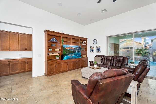 living room with visible vents and a ceiling fan