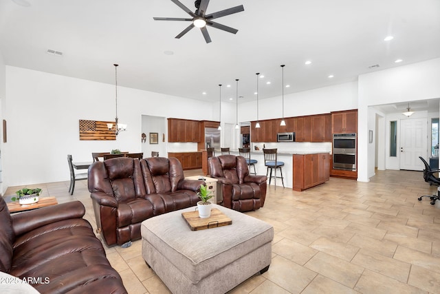 living room featuring recessed lighting, visible vents, and ceiling fan with notable chandelier