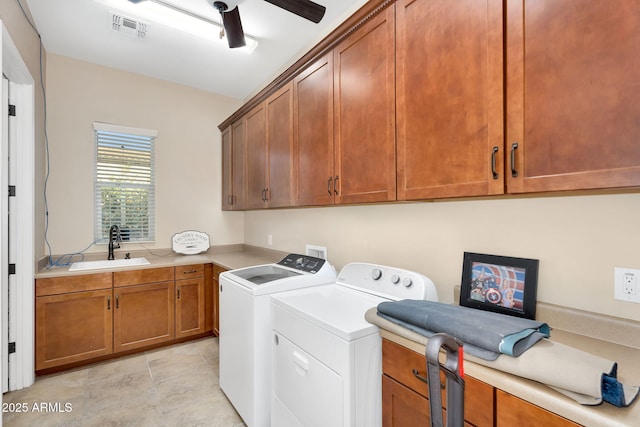 clothes washing area featuring visible vents, a sink, washer and dryer, cabinet space, and ceiling fan