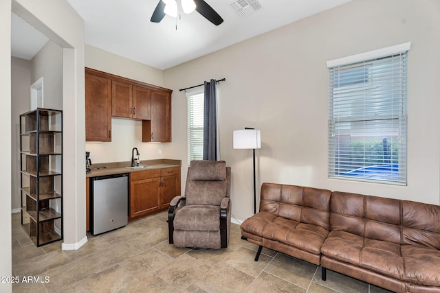 interior space with visible vents and a ceiling fan