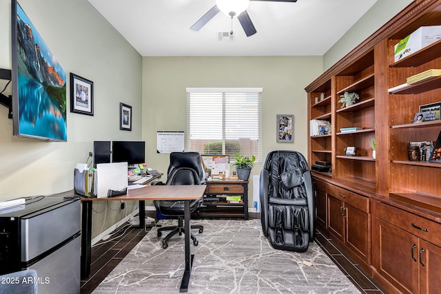 office with visible vents, light wood-style flooring, and ceiling fan