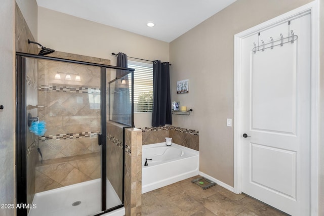 full bathroom featuring a garden tub, baseboards, and a shower stall