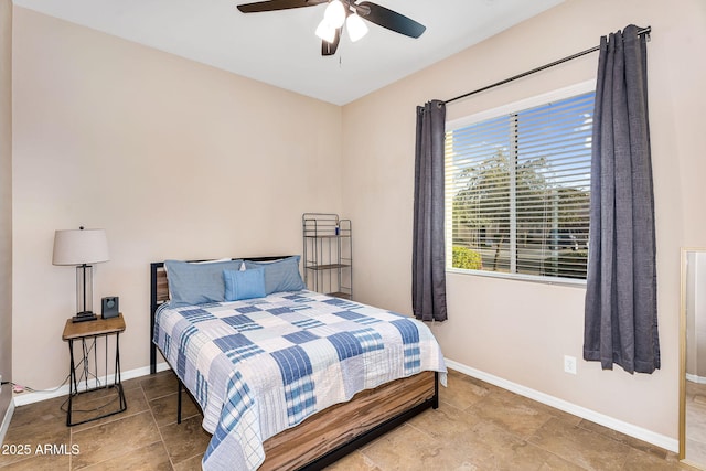 bedroom featuring baseboards and ceiling fan