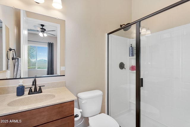 full bath featuring a ceiling fan, toilet, a stall shower, and vanity