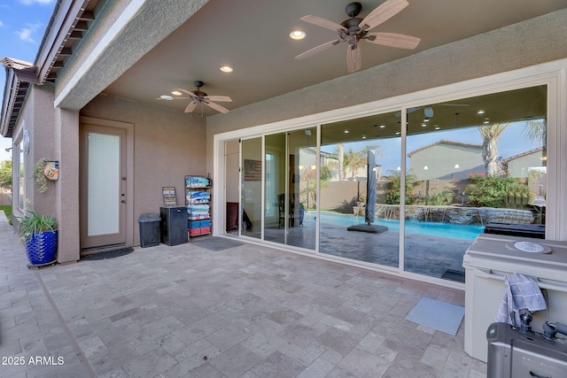 view of patio featuring a ceiling fan and a fenced in pool