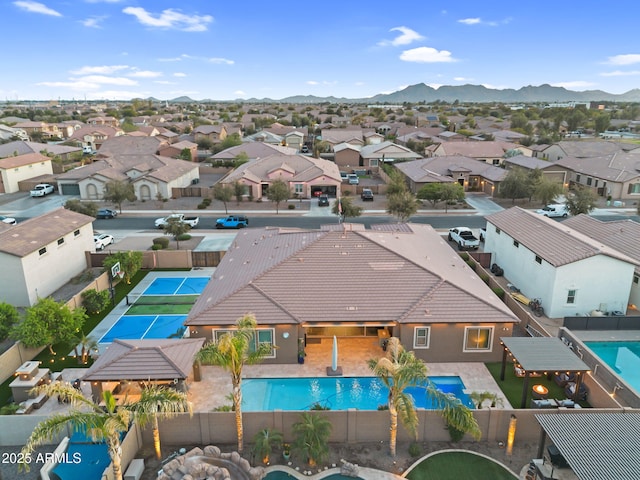 drone / aerial view featuring a residential view and a mountain view