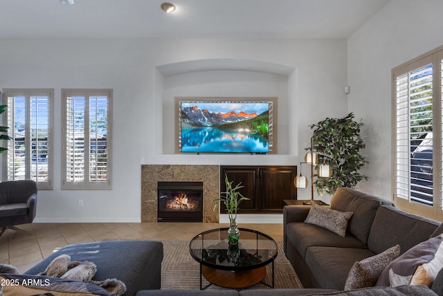 living room with light tile patterned floors and a fireplace