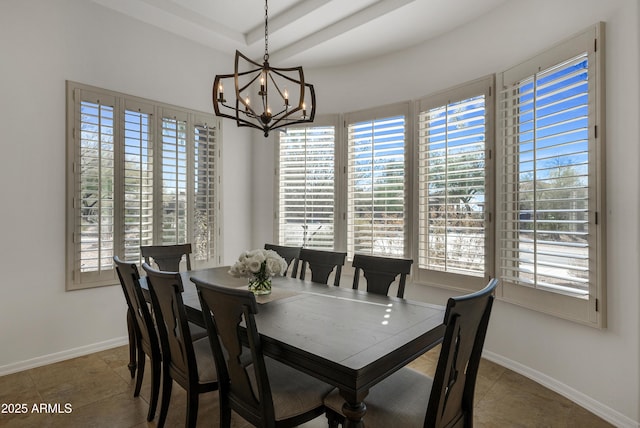 tiled dining area featuring a tray ceiling and a notable chandelier