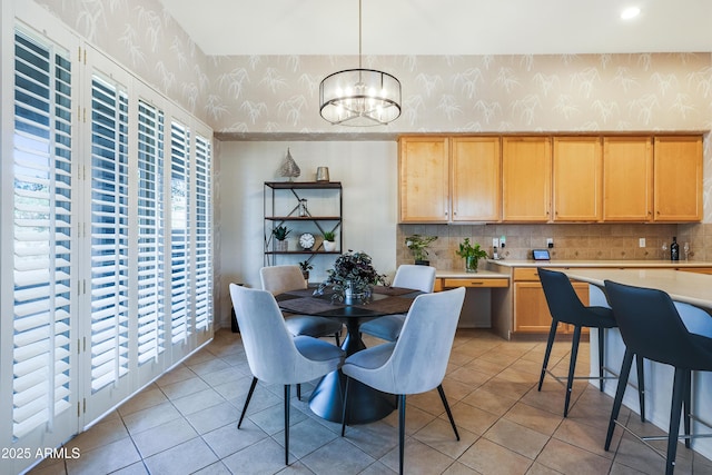 tiled dining space with a notable chandelier