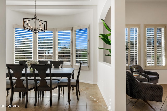 tiled dining room featuring a notable chandelier