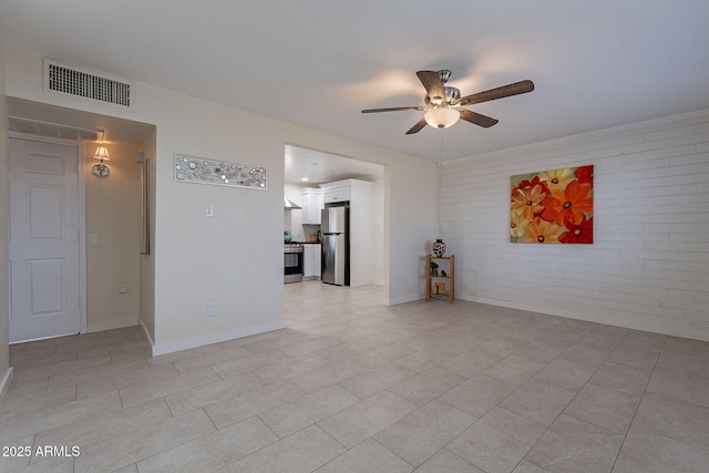 spare room with brick wall and ceiling fan