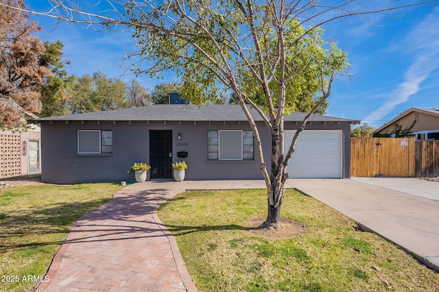 single story home featuring a garage and a front yard