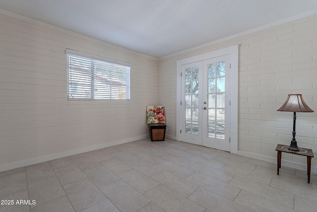 entryway featuring a wealth of natural light, french doors, and brick wall