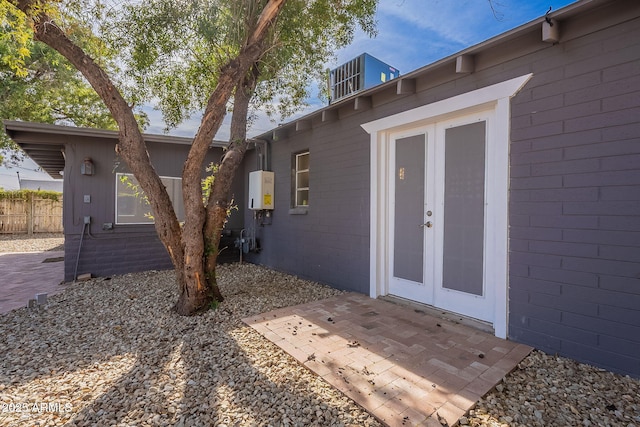 exterior space with central AC unit and a patio