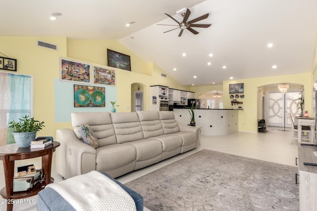 living room featuring ceiling fan and high vaulted ceiling