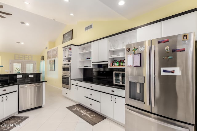 kitchen featuring white cabinetry, ceiling fan, backsplash, vaulted ceiling, and appliances with stainless steel finishes