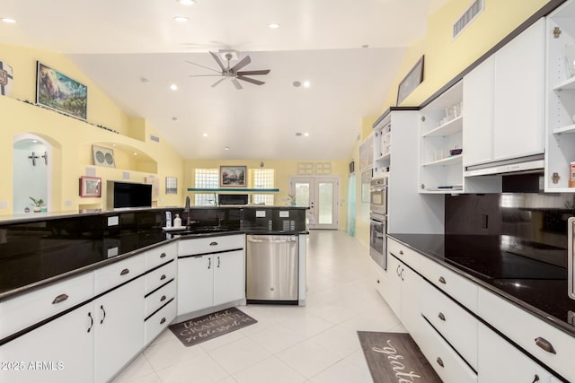 kitchen with sink, white cabinets, lofted ceiling, and appliances with stainless steel finishes