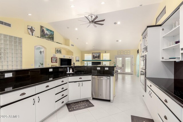 kitchen with white cabinetry, french doors, sink, vaulted ceiling, and appliances with stainless steel finishes