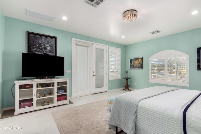 tiled bedroom featuring a chandelier