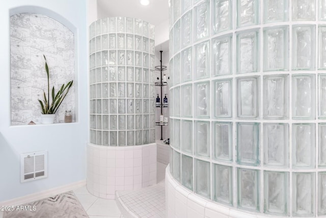 bathroom with tile patterned floors and a shower